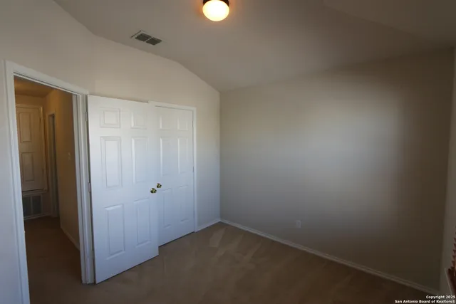 an empty room with closet area