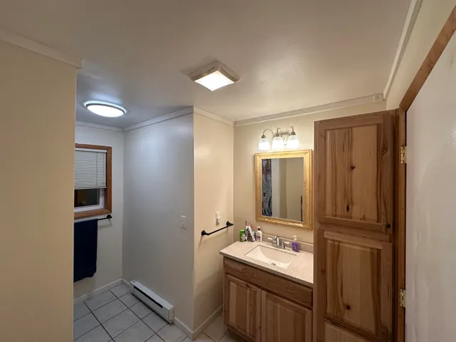 a bathroom with a double vanity sink and mirror