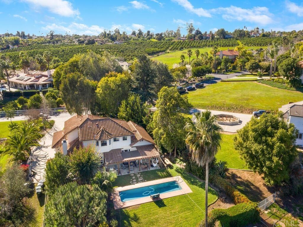 an aerial view of residential houses with outdoor space and swimming pool