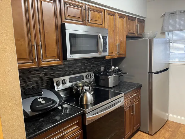 a kitchen with a stove and a microwave