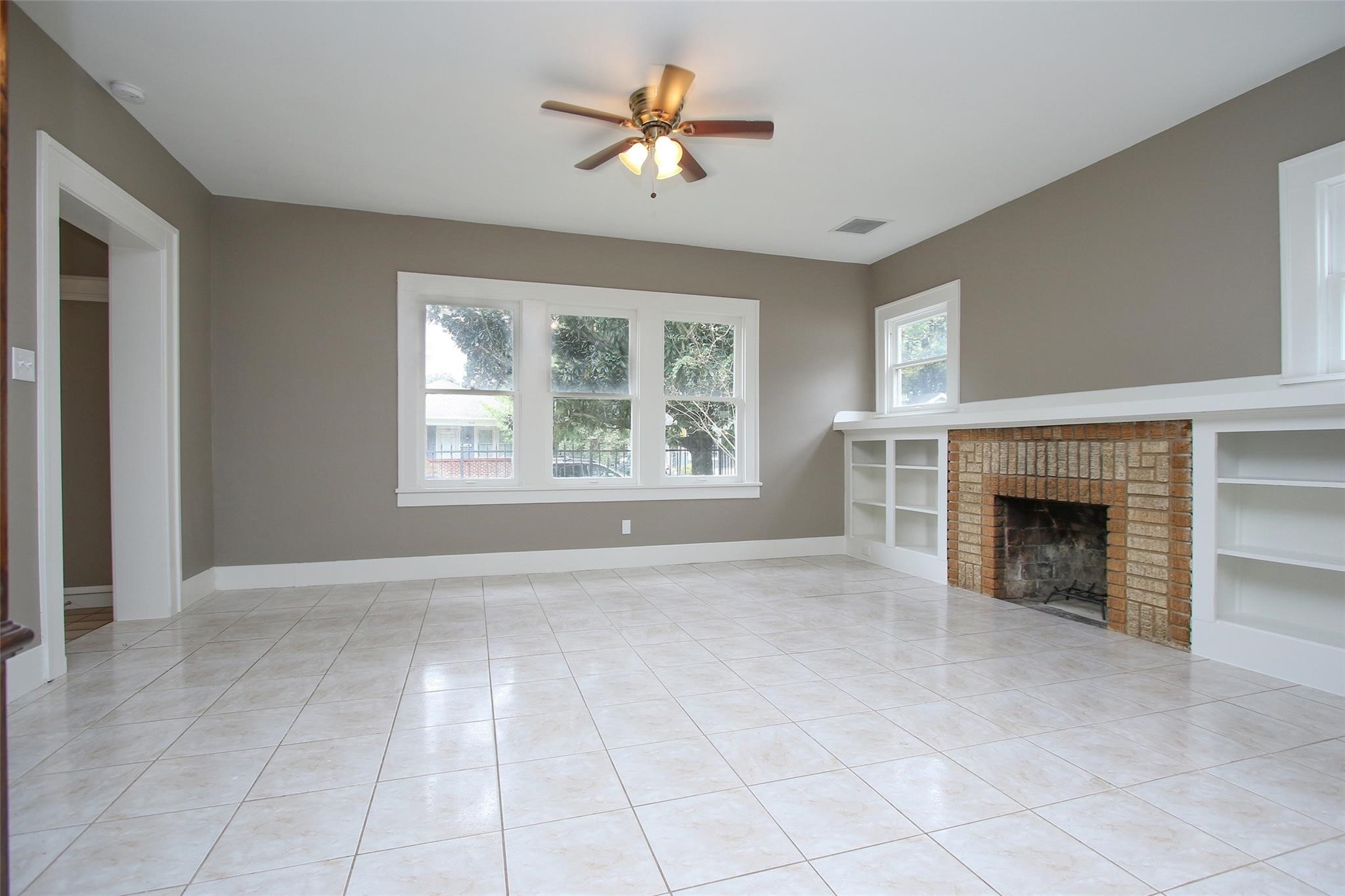 1127 Walling Street Houston, TX 77009 - Photo 12 of 23 a view of an empty room with window and a fireplace