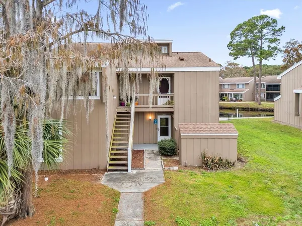 a front view of a house with a garden and plants