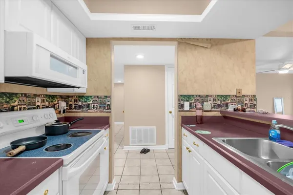 a kitchen with stainless steel appliances granite countertop a sink and cabinets