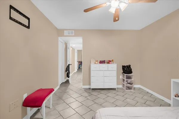 a bathroom with a bathtub shower sink vanity mirror and toilet