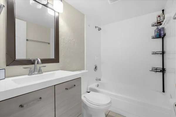 a bathroom with a sink a toilet and mirror