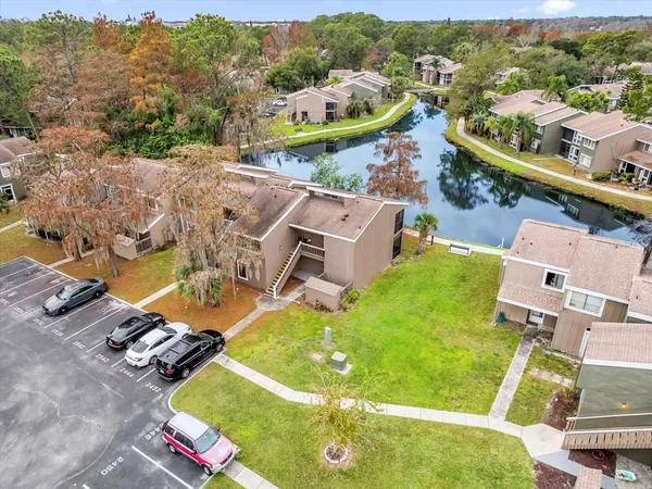 a view of a swimming pool with a yard and lake view