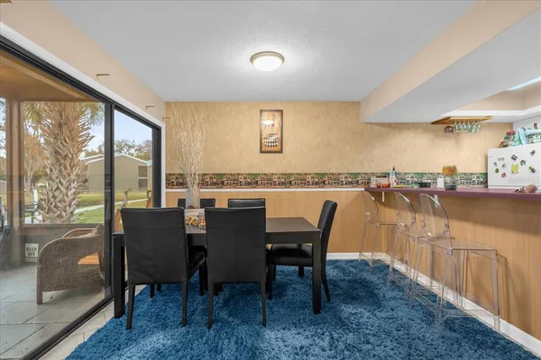 a view of a dining room with furniture and a window