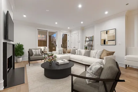 a living room with furniture potted plant and a window