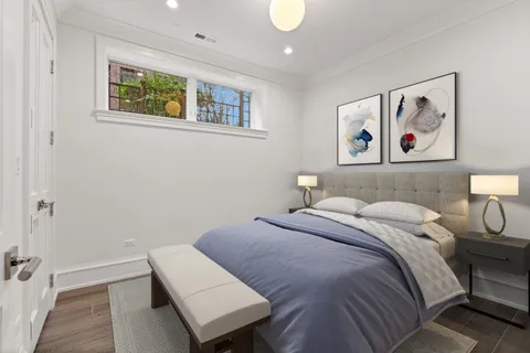 a bedroom with a bed and a painting on the wall