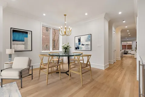 a view of a a dining room with furniture window and wooden floor