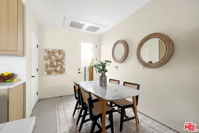 a view of a dining room with furniture and a potted plant