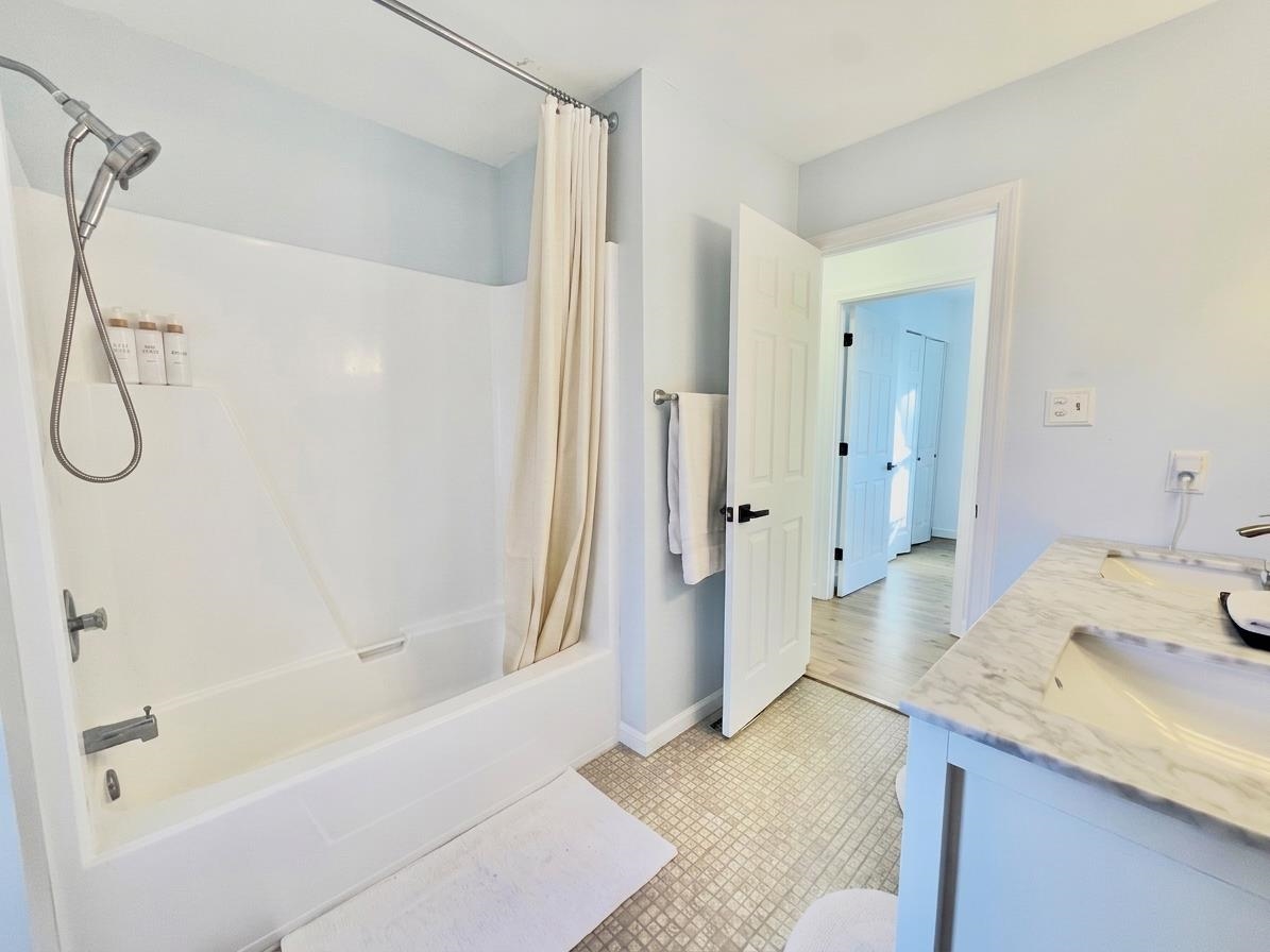 510 Portsmouth Road Cape May, NJ 08204 - Photo 18 of 41 a bathroom with a granite countertop sink a mirror and a bath tub