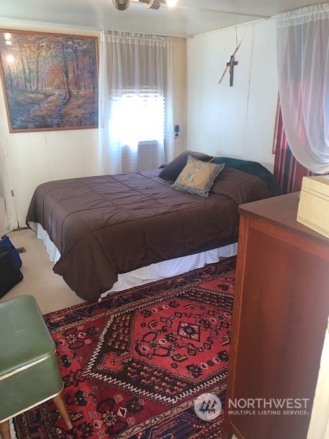 23708 Locust Way, Unit 45 Bothell, WA 98021 - Photo 9 of 13 a bedroom with a bed and a painting on the wall