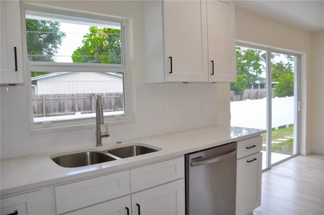 a kitchen with a sink and large window