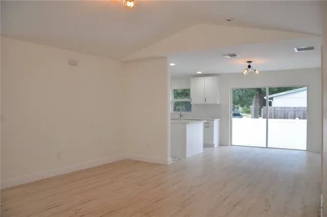 a view of a kitchen with a sink and a large window