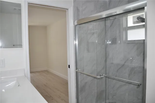 a bathroom with a glass shower door
