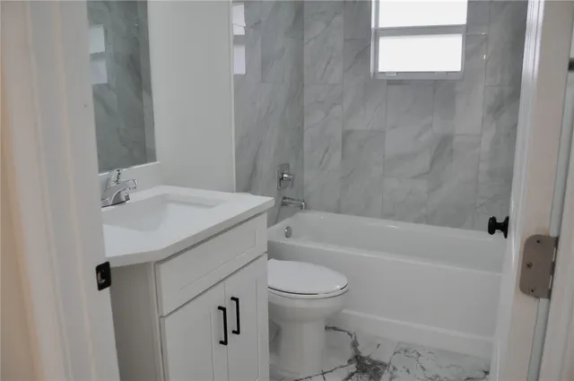 a bathroom with a sink a toilet and a bathtub