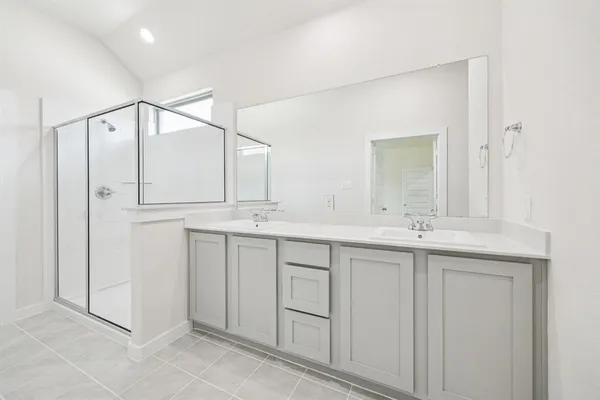 a bathroom with a double vanity sink and mirror
