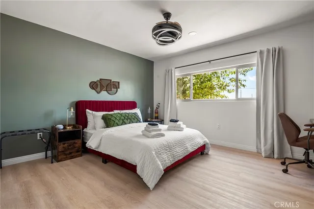 a bedroom with a bed and a chandelier