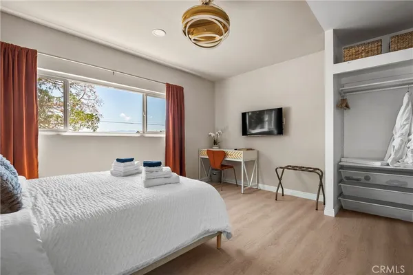 a bedroom with a bed and a tv on table