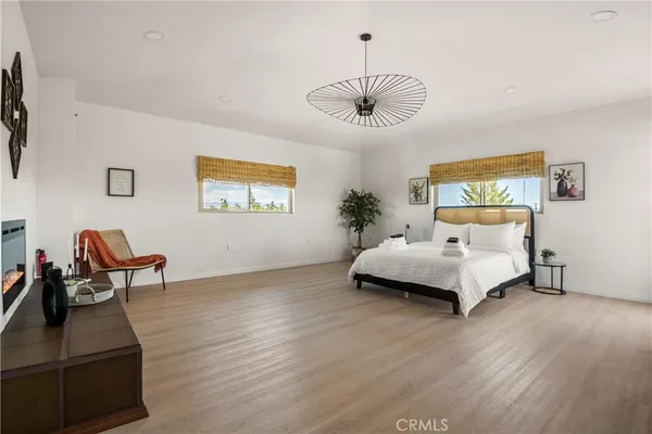 a bedroom with a bed and a chandelier