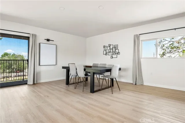 a view of a work space with wooden floor and furniture