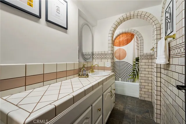 a bathroom with a sink a mirror and a bathtub