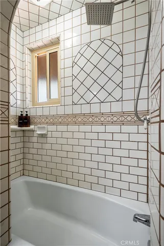 a bathroom with a bathtub and a shower