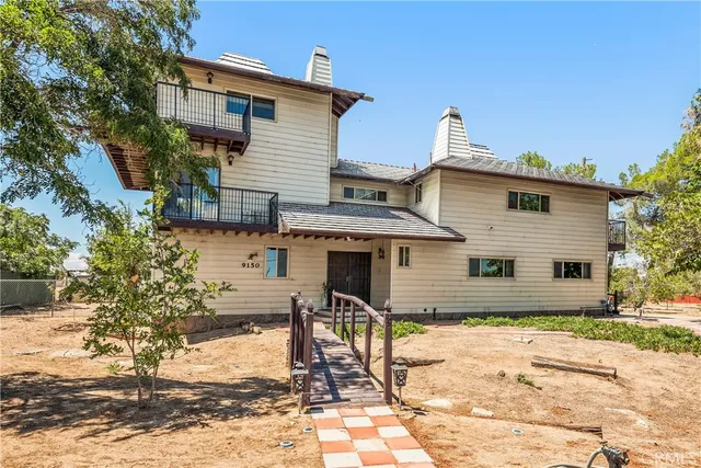a view of a chairs and table in the backyard