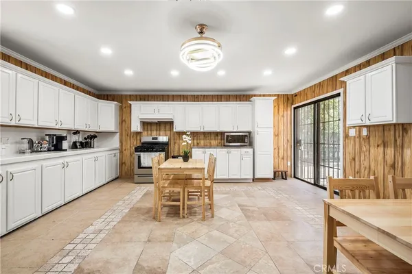 a kitchen with a refrigerator and white cabinets