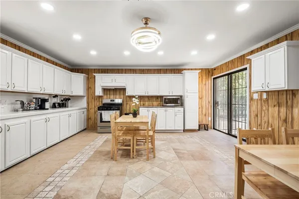 a kitchen with a refrigerator and white cabinets