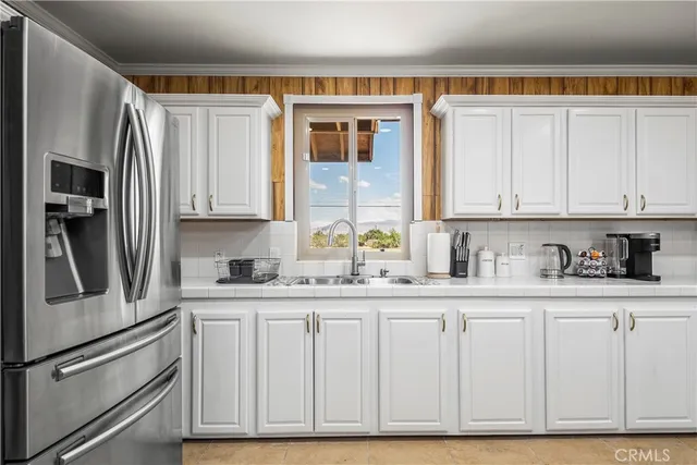 a kitchen with granite countertop a sink and cabinets