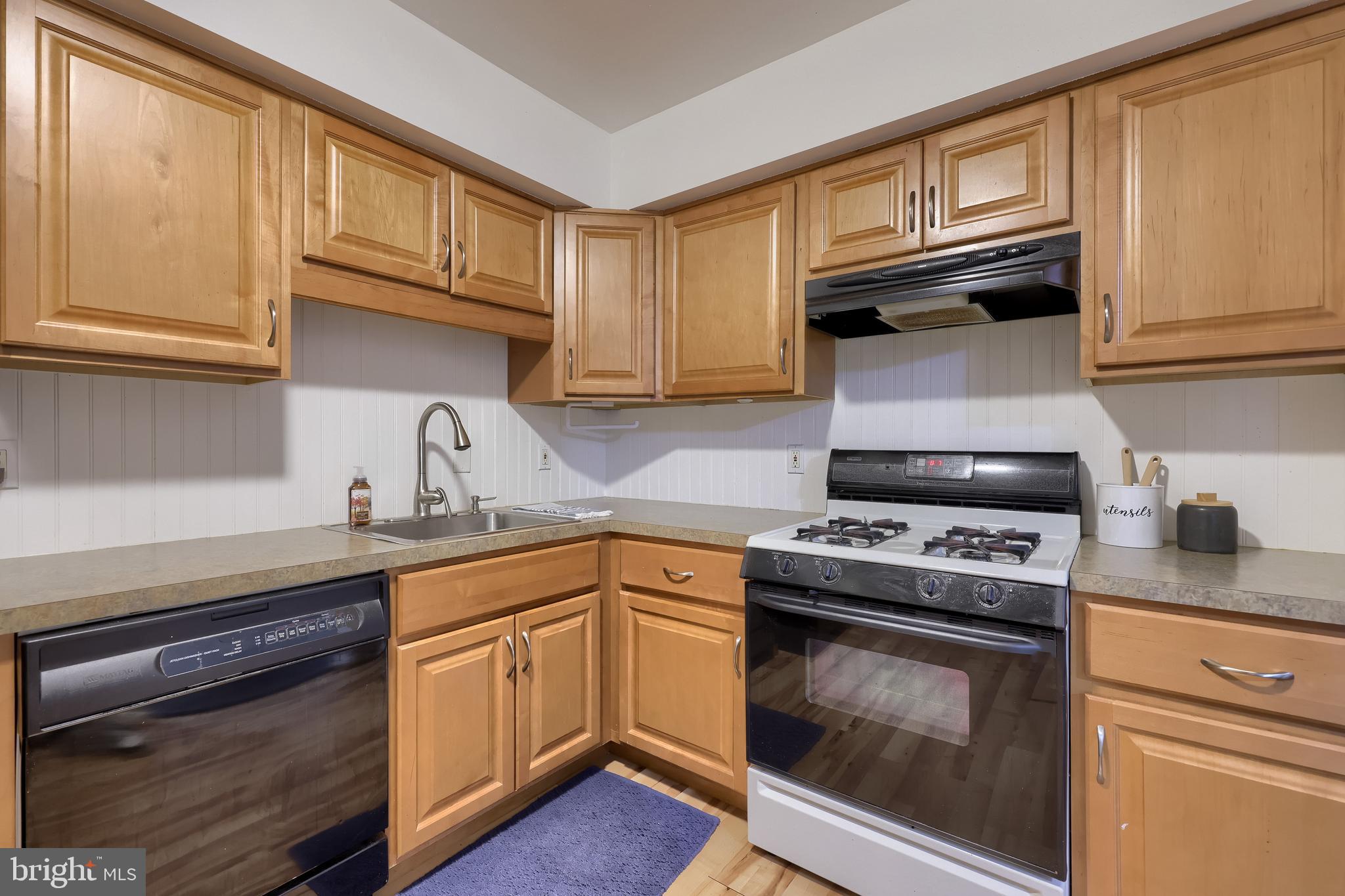 2900 State Hill Road, Unit I5 Reading, PA 19610 - Photo 10 of 26 a kitchen with cabinets wooden floor and stainless steel appliances