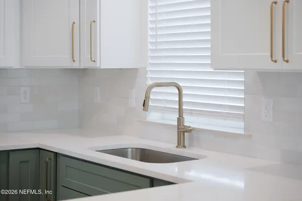 a kitchen with a sink and cabinets