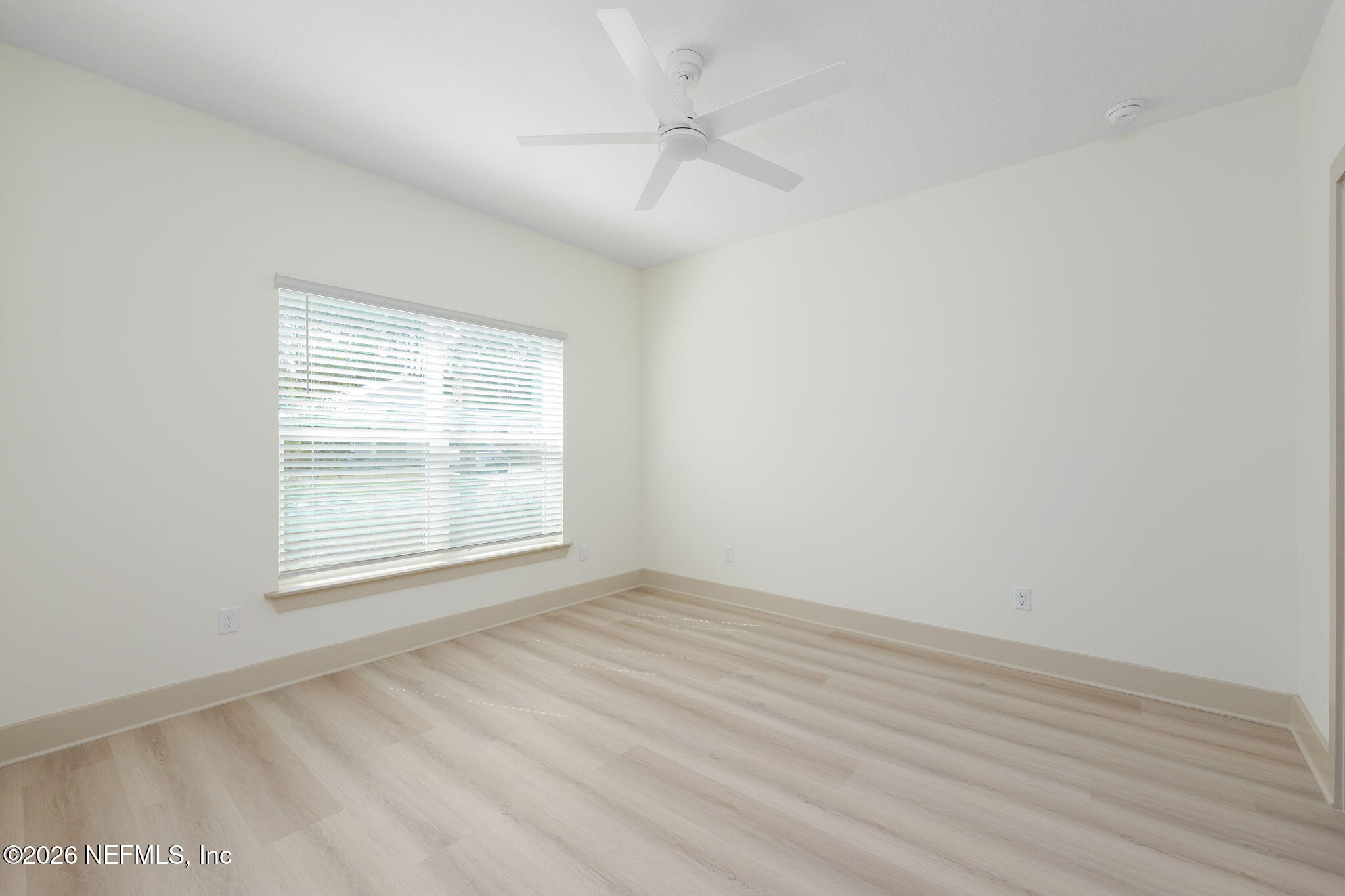 716 West 6th Street St. Augustine, FL 32084 - Photo 13 of 28 an empty room with wooden floor and windows