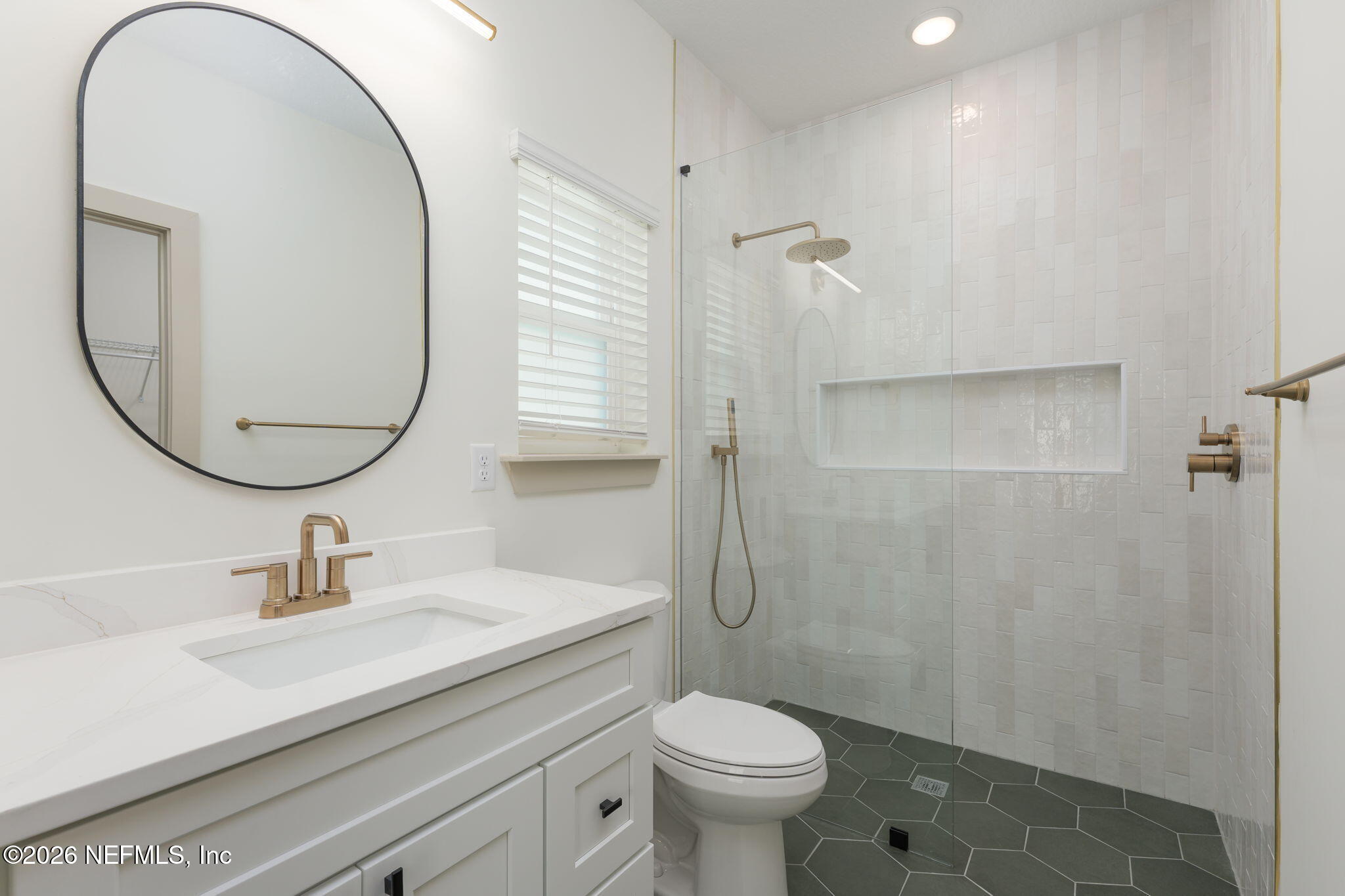 716 West 6th Street St. Augustine, FL 32084 - Photo 15 of 28 a bathroom with a sink a toilet and a mirror