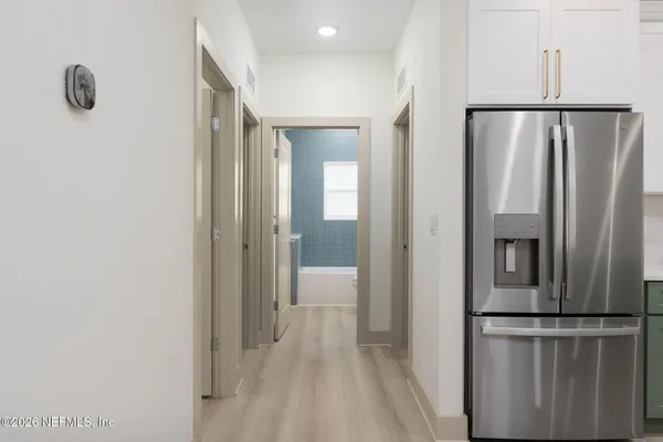 a view of a kitchen with a refrigerator and a window