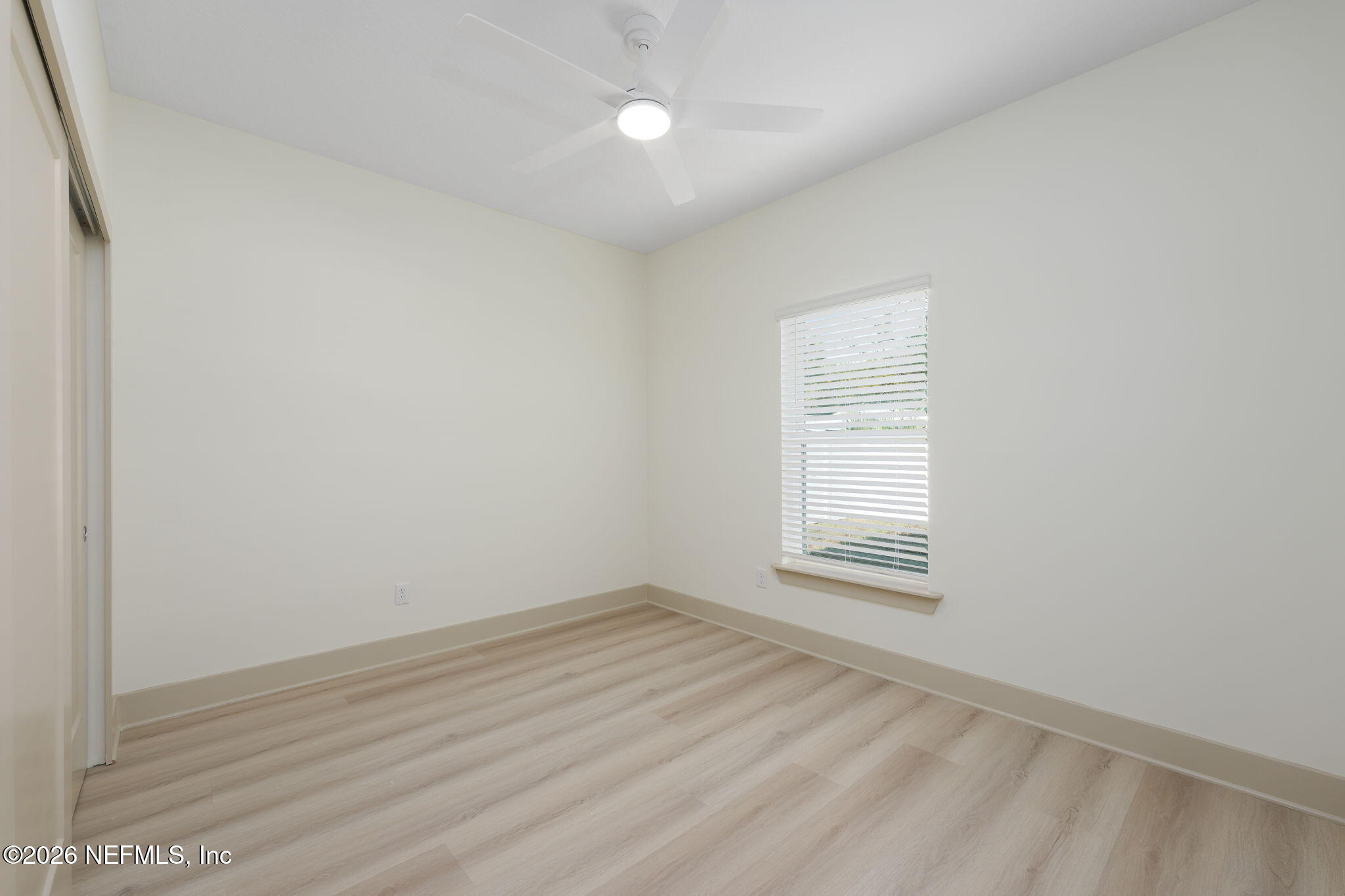 716 West 6th Street St. Augustine, FL 32084 - Photo 19 of 28 an empty room with wooden floor and windows