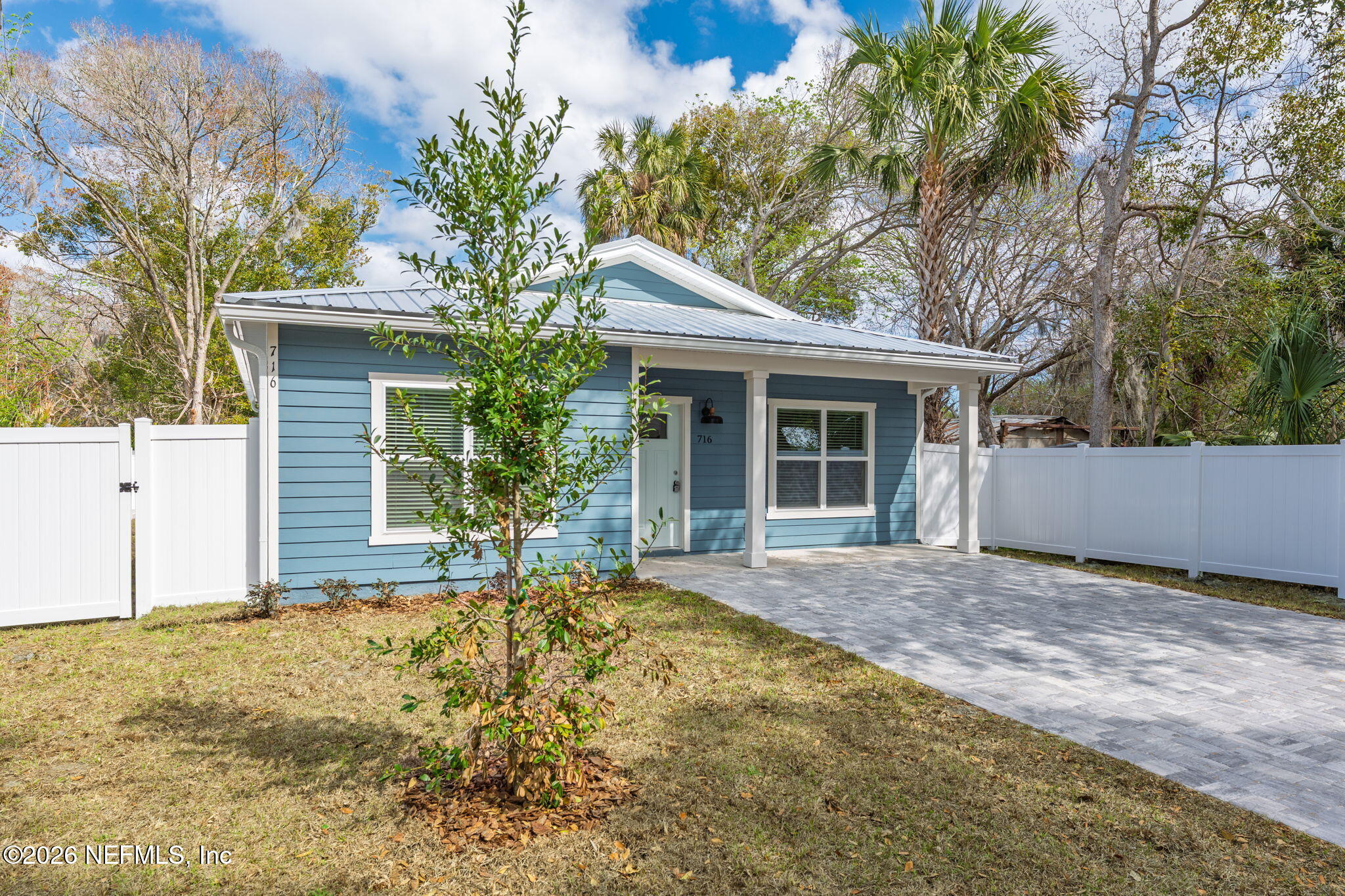 716 West 6th Street St. Augustine, FL 32084 - Photo 2 of 28 a front view of house with yard and trees around
