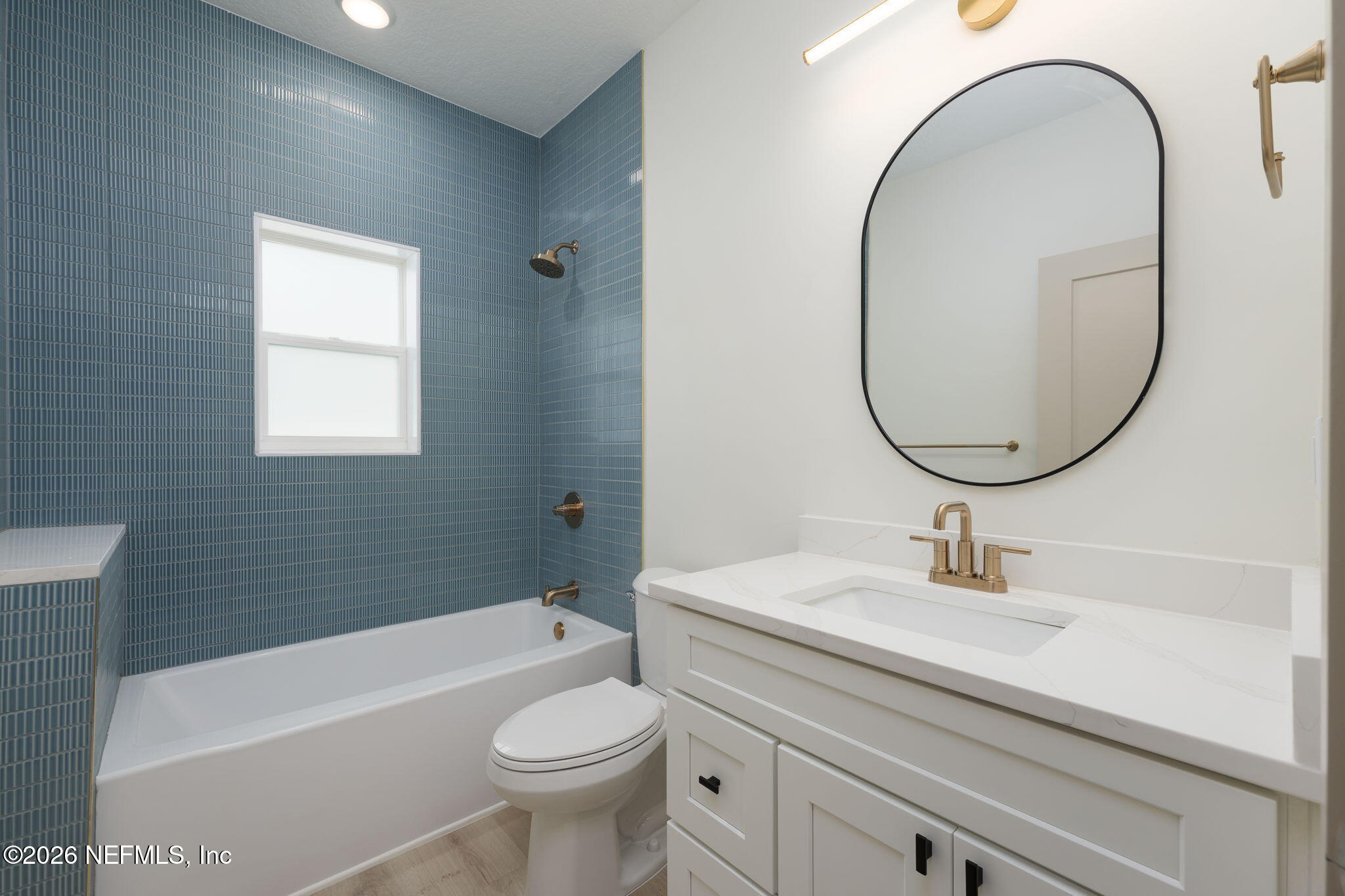 716 West 6th Street St. Augustine, FL 32084 - Photo 21 of 28 a bathroom with a sink a toilet and a mirror