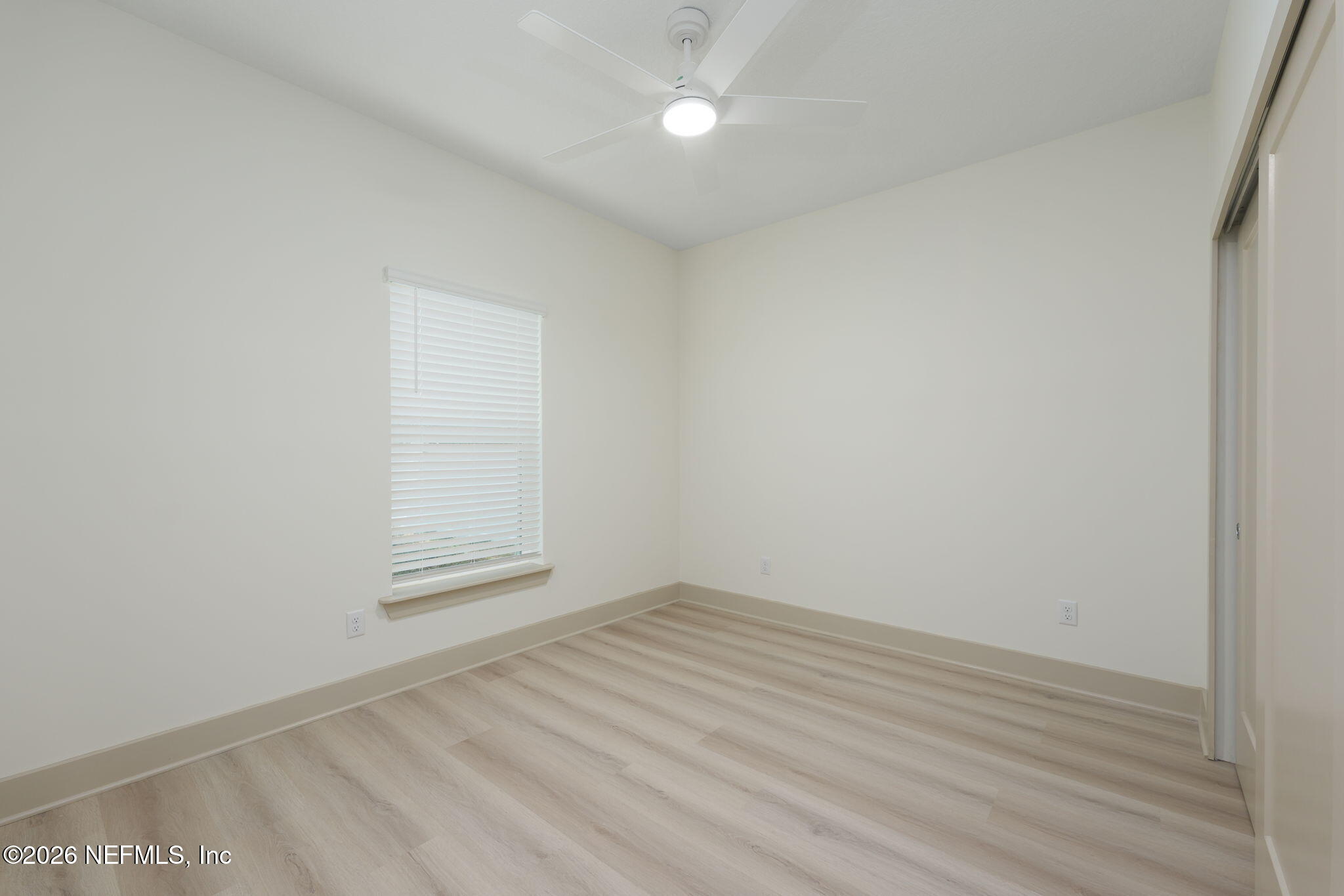 716 West 6th Street St. Augustine, FL 32084 - Photo 24 of 28 an empty room with wooden floor and fan