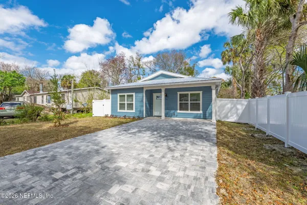 a view of a house with a backyard