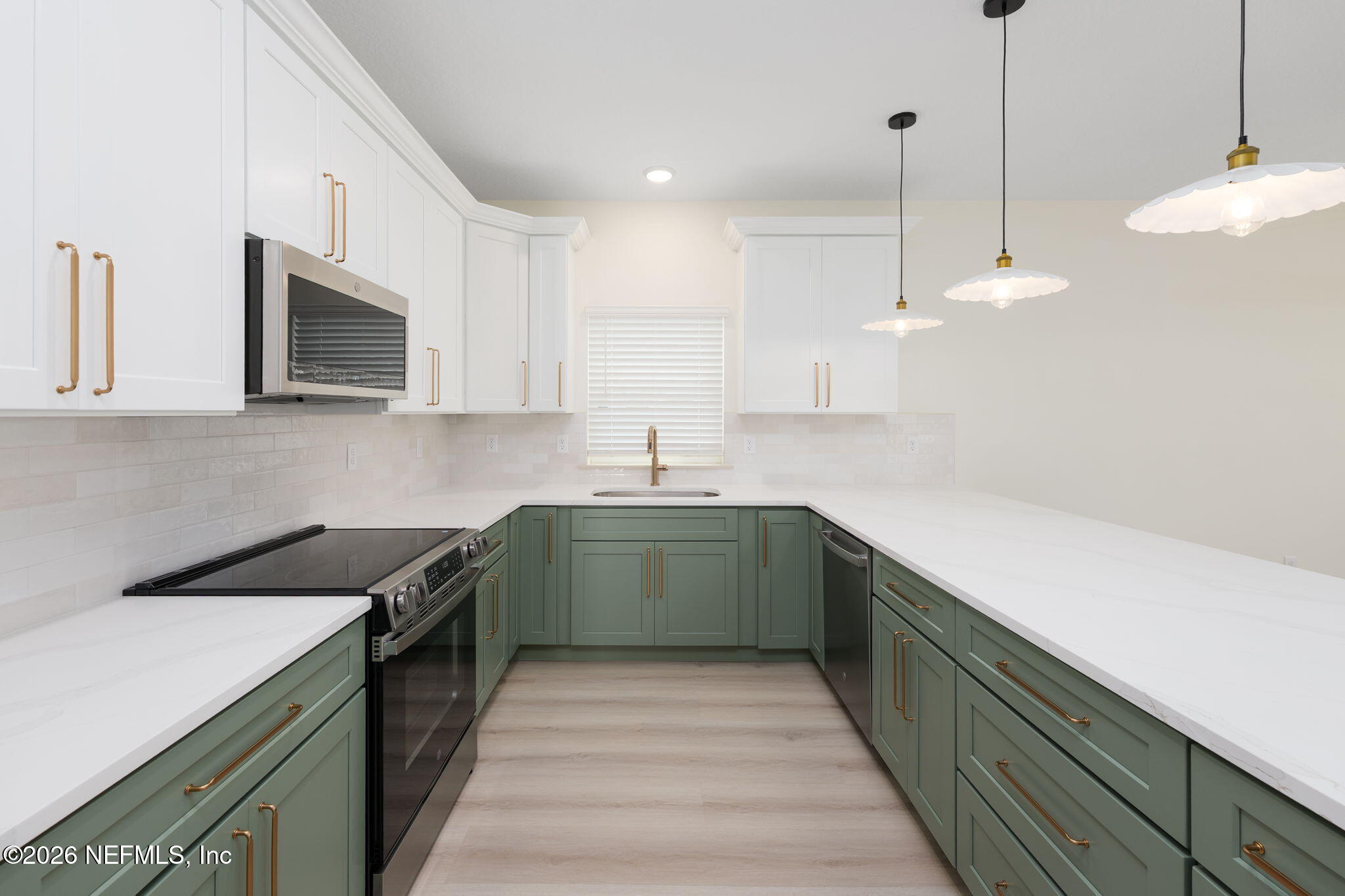 716 West 6th Street St. Augustine, FL 32084 - Photo 6 of 28 a kitchen with a sink and cabinets