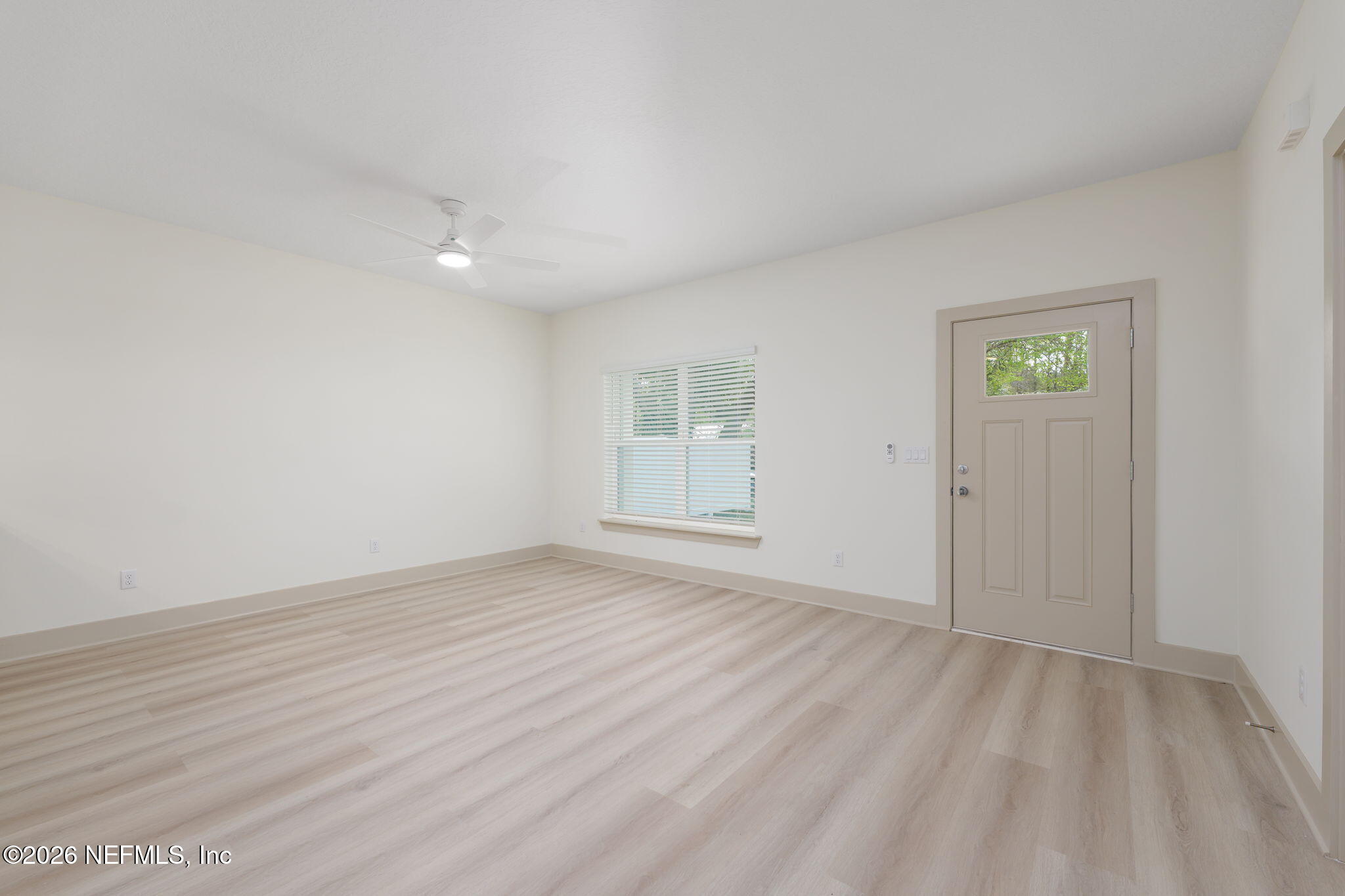 716 West 6th Street St. Augustine, FL 32084 - Photo 8 of 28 a view of an empty room with wooden floor and a window