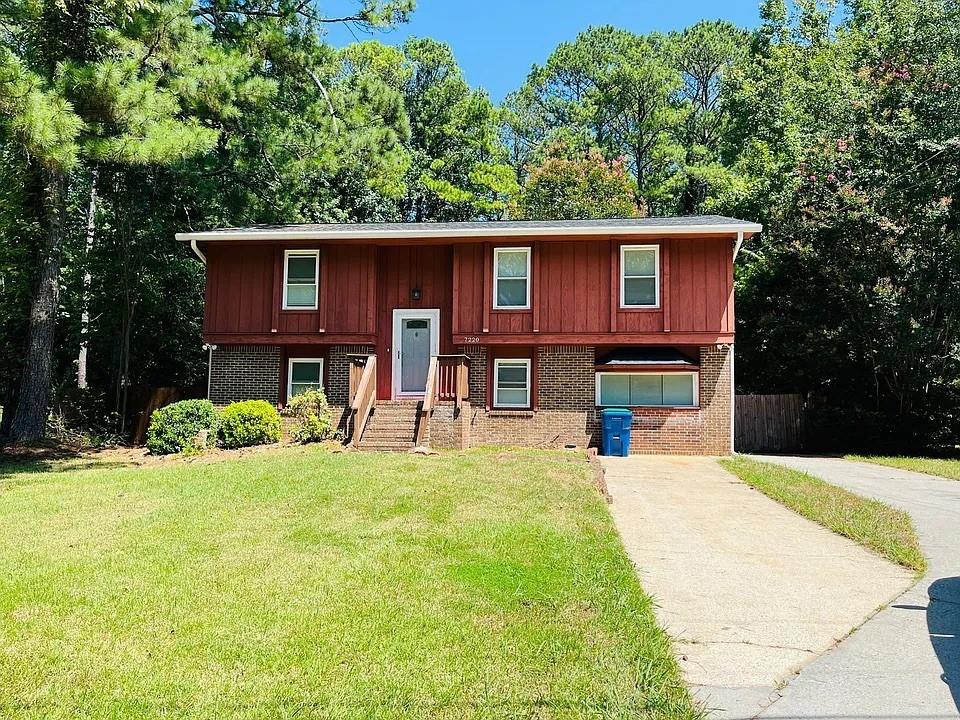 a view of a yard with table and chairs under an umbrella
