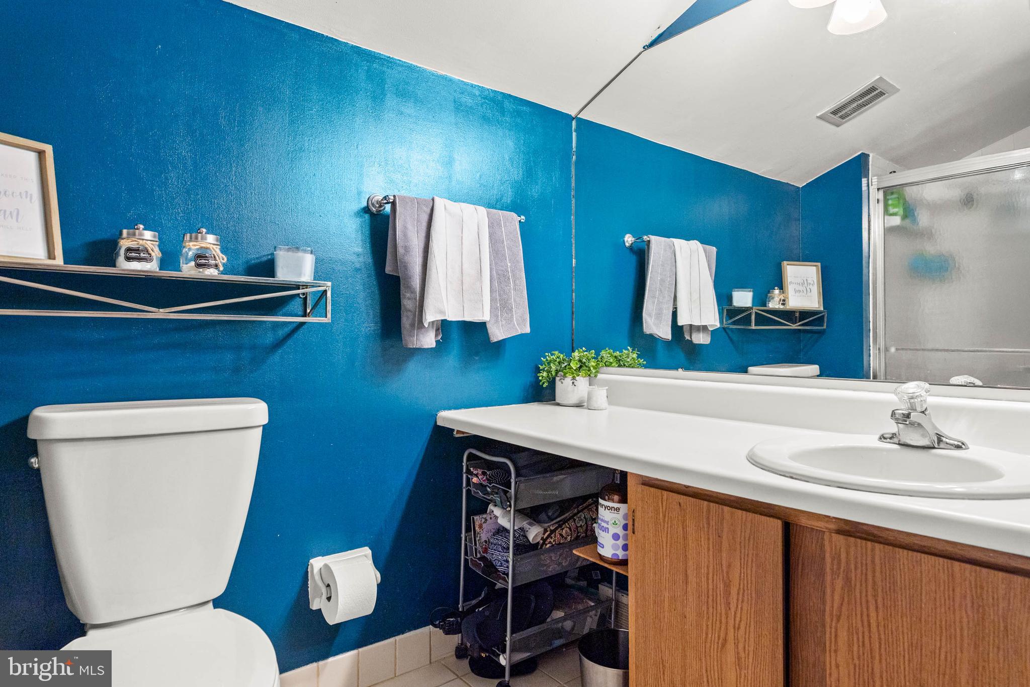 2201 Aspen Circle Springfield, PA 19064 - Photo 13 of 18 a bathroom with a toilet sink and mirror