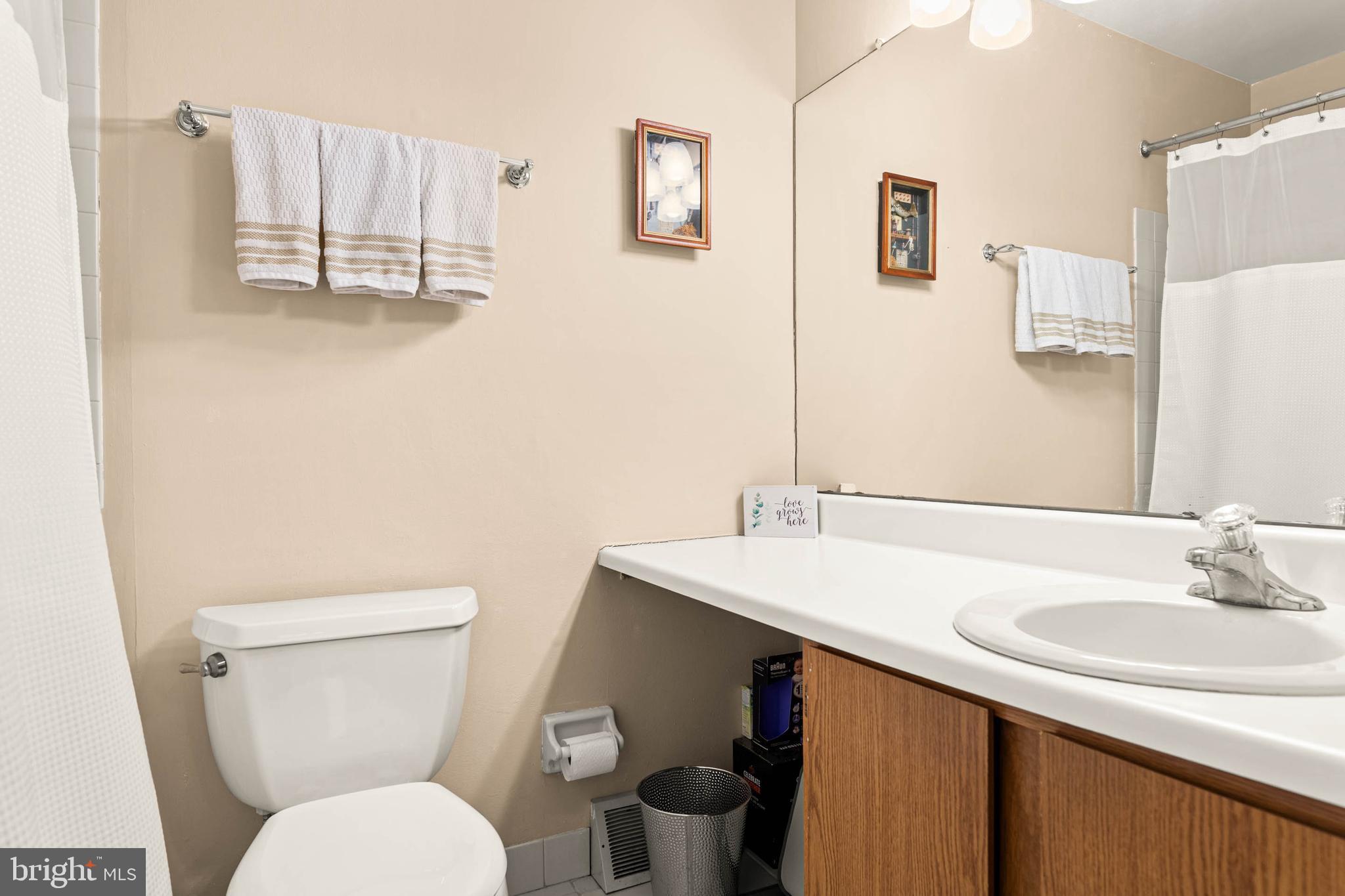 2201 Aspen Circle Springfield, PA 19064 - Photo 18 of 18 a bathroom with a toilet sink and mirror