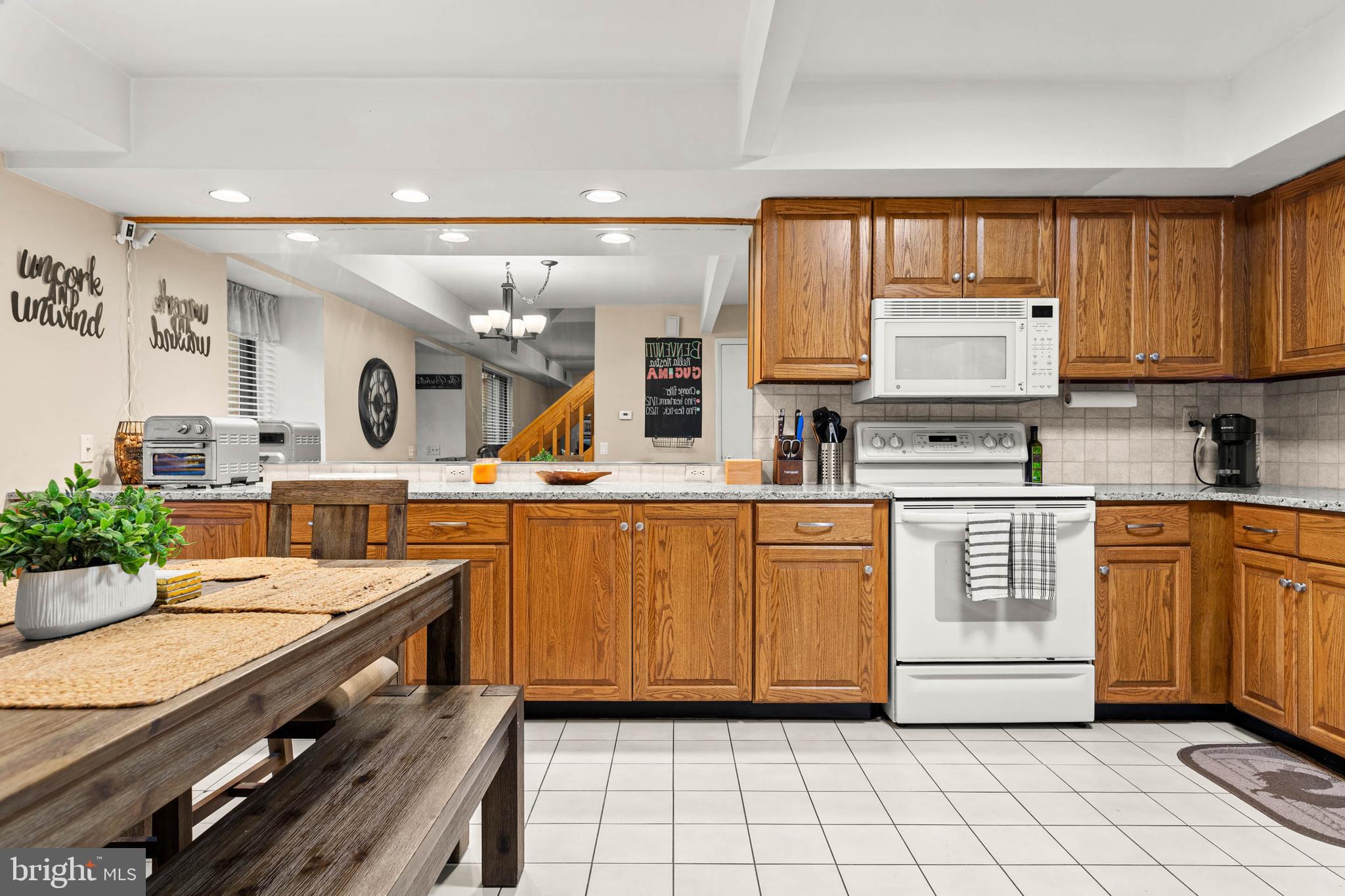 2201 Aspen Circle Springfield, PA 19064 - Photo 6 of 18 a kitchen with stainless steel appliances a stove sink and cabinets