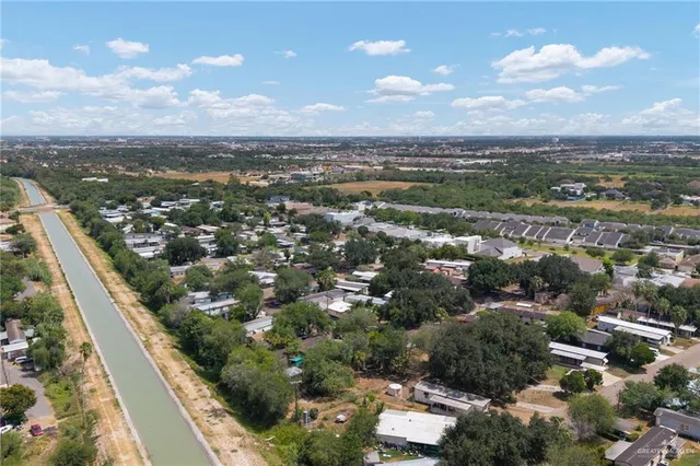an aerial view of residential houses with outdoor space and seating