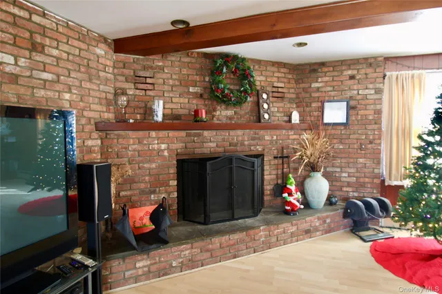 a view of a patio with a table and chairs and a fireplace